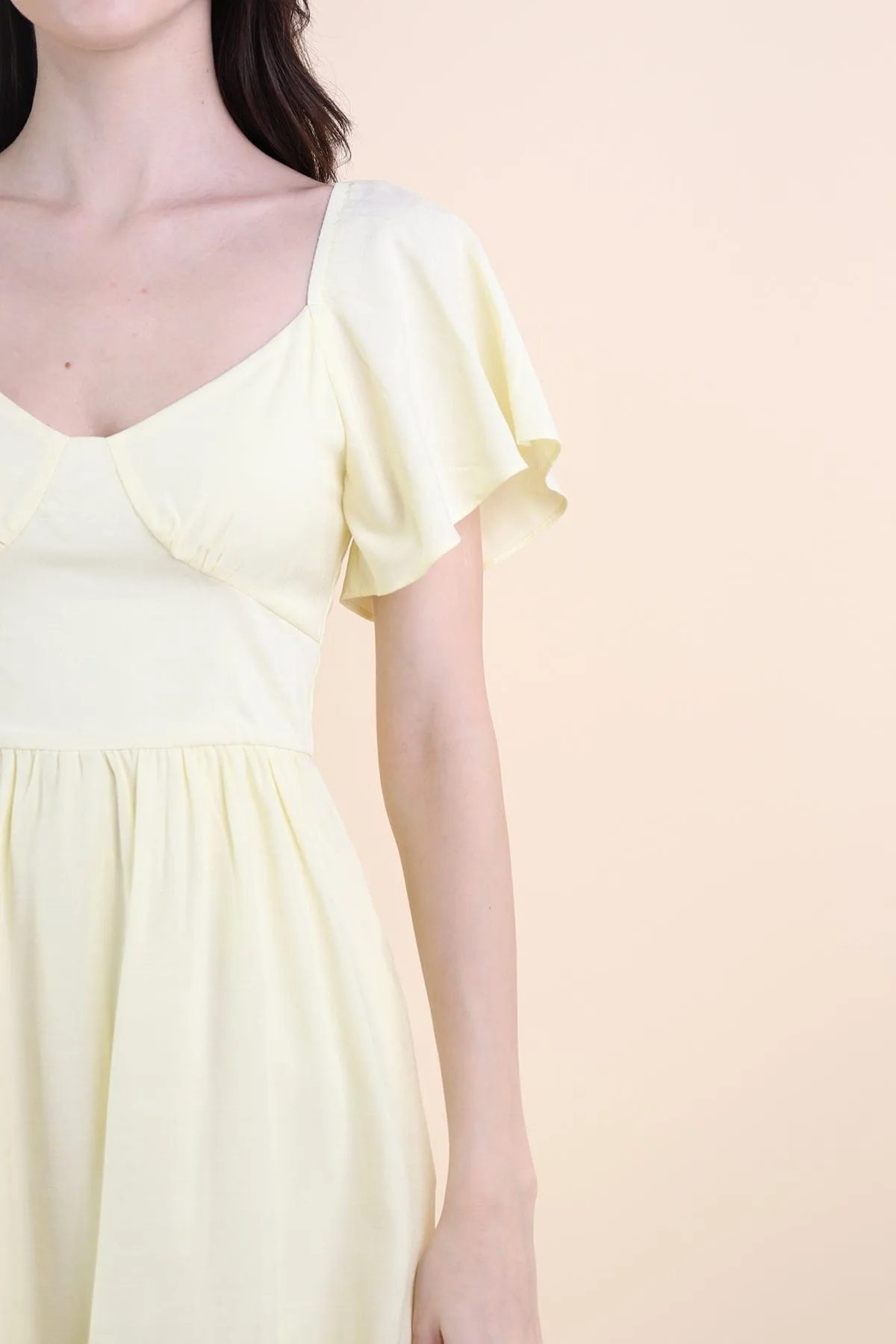 VENETIA ROMPER DRESS IN PALE DAFFODIL