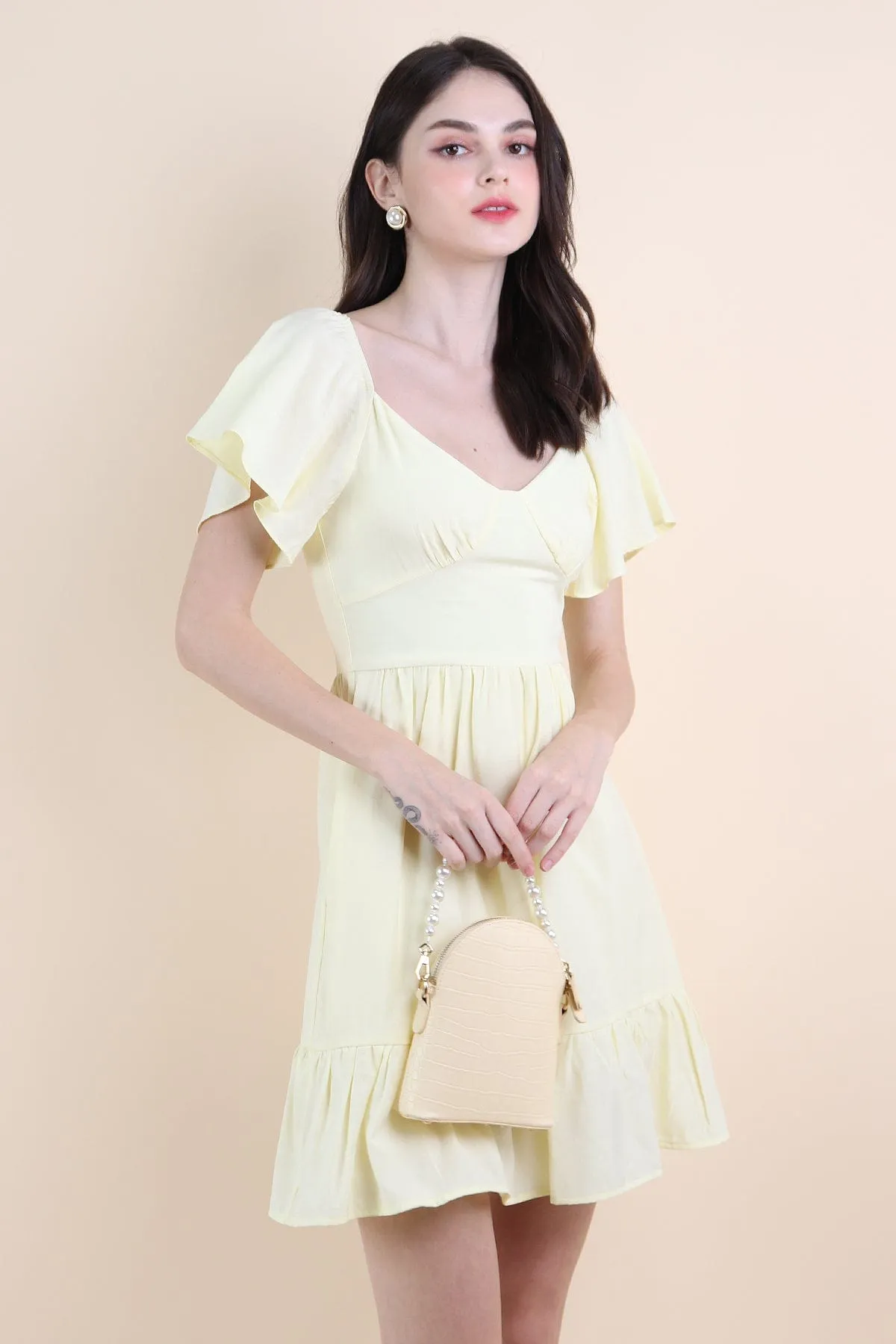 VENETIA ROMPER DRESS IN PALE DAFFODIL